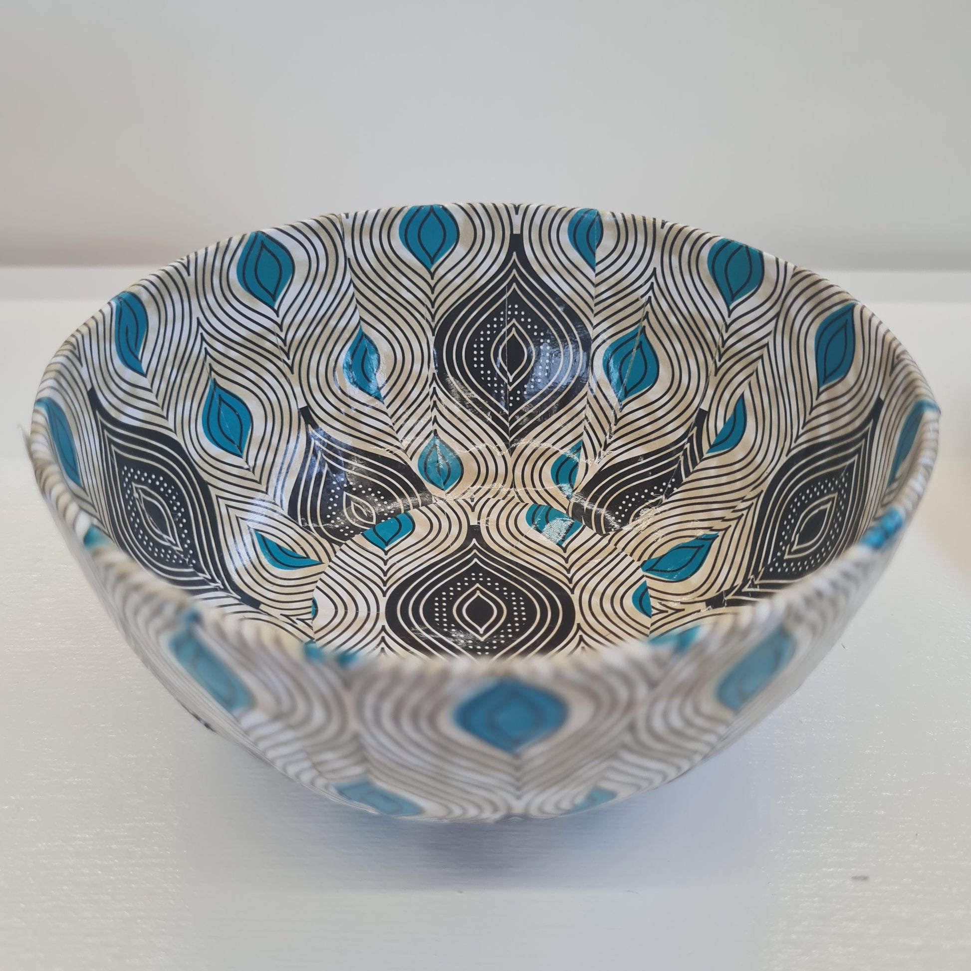 blue white and black paper mache bowl