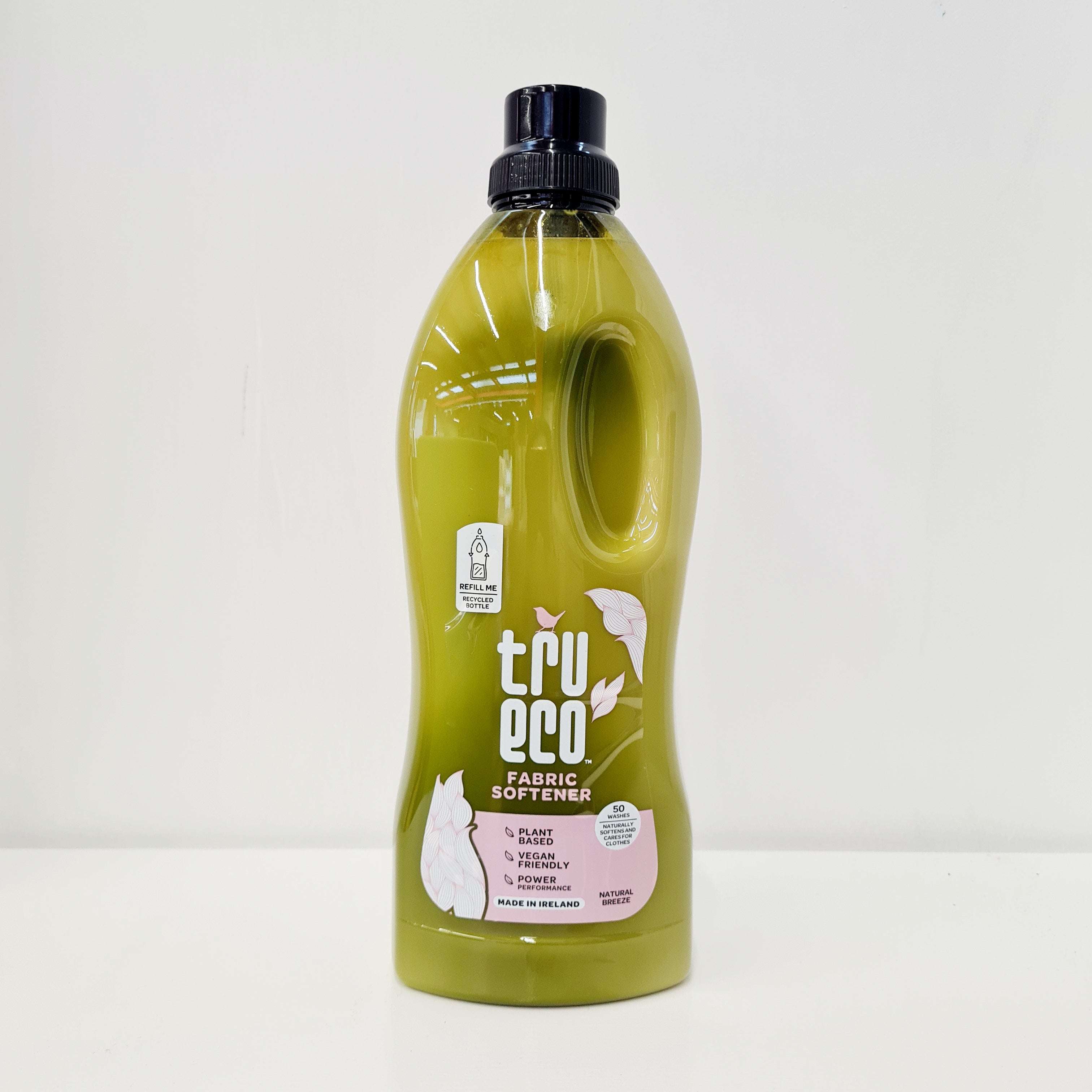 A bottle of TruEco fabric softener with a green label, indicating that it is eco-friendly and made from plant-based ingredients.